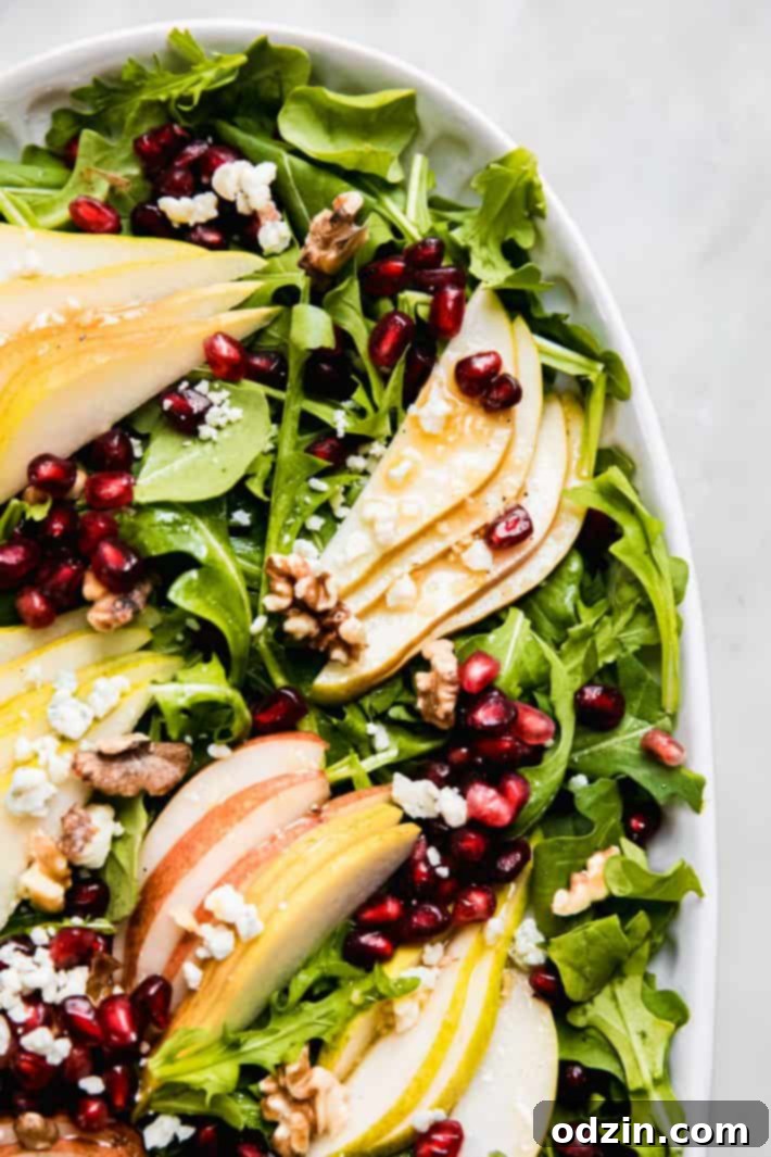 Platter of pear and walnut salad with dressing on the side