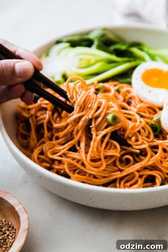 chopsticks holding Gochujang noodles