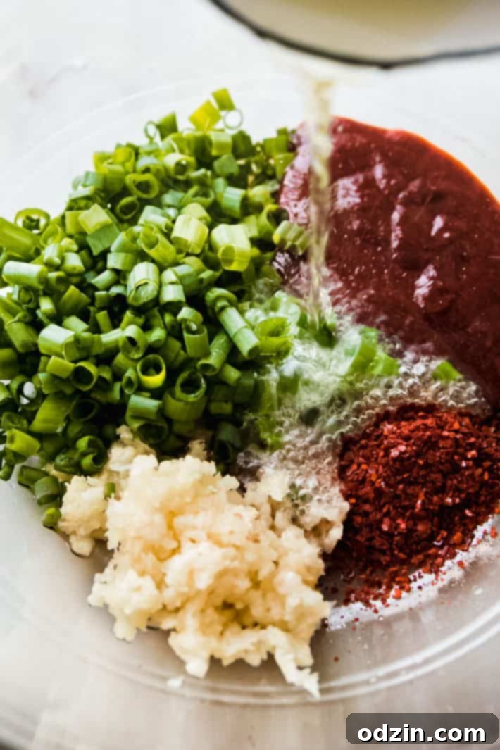pouring hot oil over Korean pepper paste, scallions, and garlic