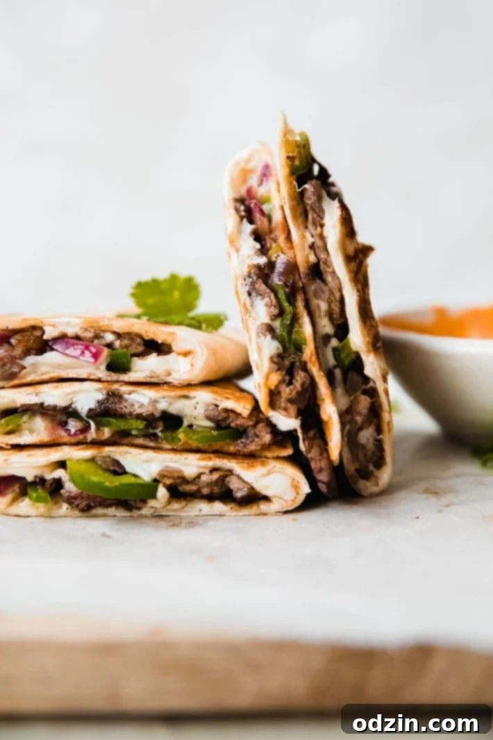 Chipotle Philly Cheesesteak Quesadillas 3 chipotles steak quesadillas stacked and standing