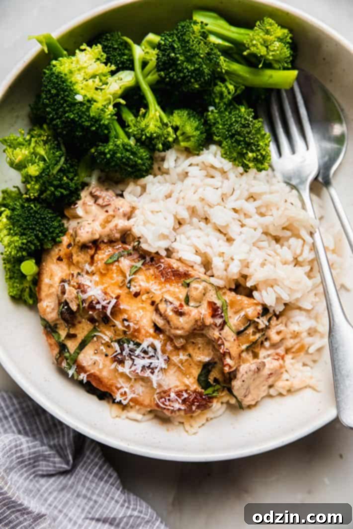 The Ultimate Marry Me Chicken Recipe 7 Marry Me Chicken served on a plate with fluffy white rice and steamed broccoli, a complete and satisfying meal.