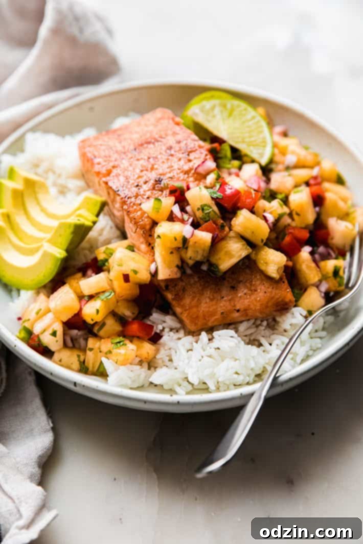 Golden Glazed Salmon with Tropical Pineapple Salsa 3 salmon with pineapple salsa and avocado slices over rice