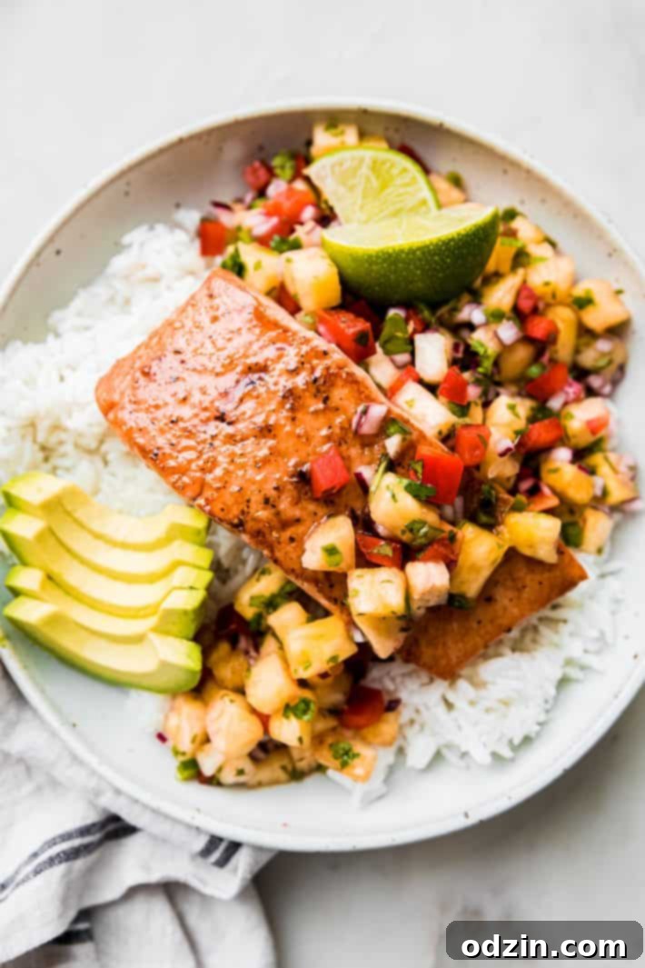 Golden Glazed Salmon with Tropical Pineapple Salsa 7 pineapple salsa salmon in bowl with lime wedges and avocado slices