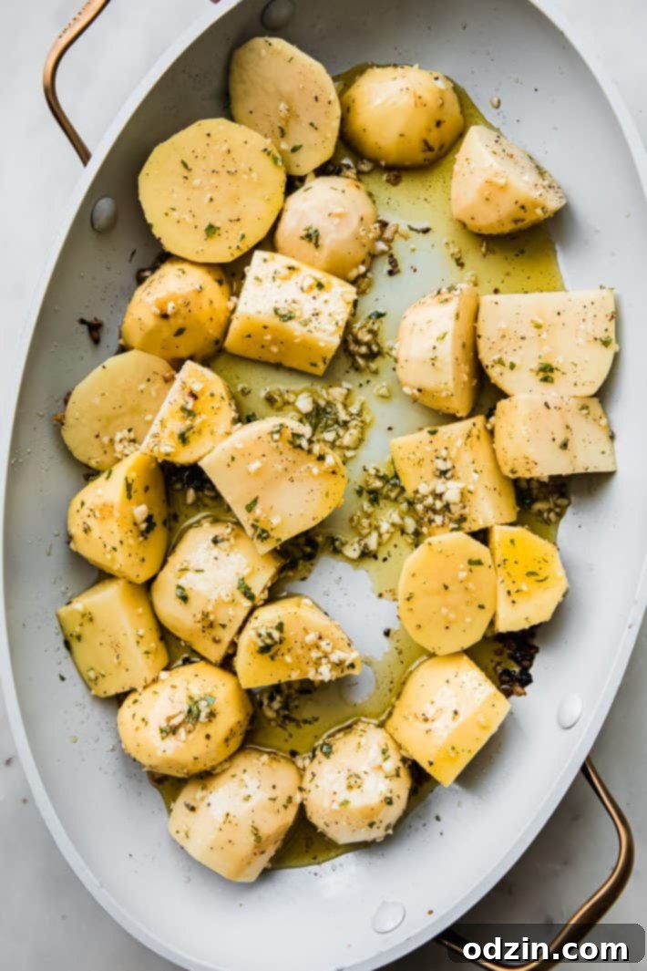 potatoes in roasting pan with oregano and garlic