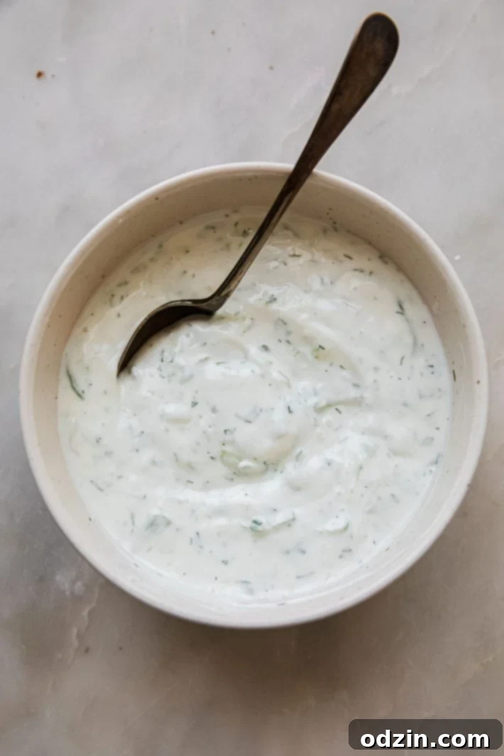 tzatziki sauce in bowl with spoon