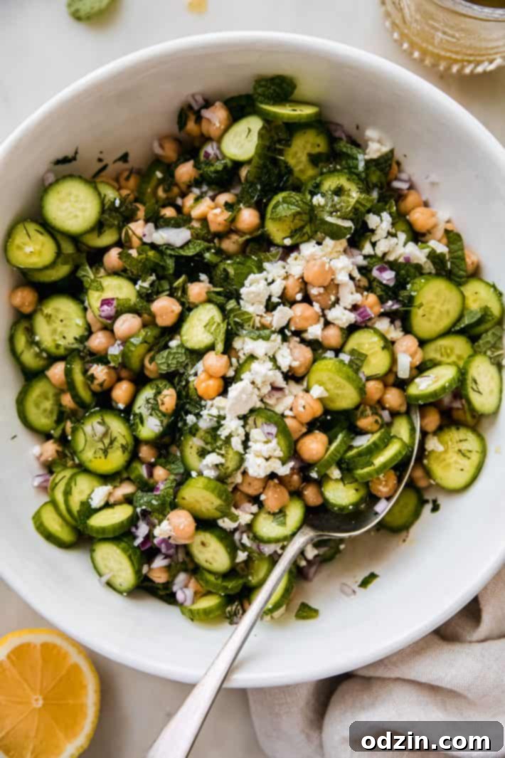 cucumber chickpea salad in bowl topped with feta cheese