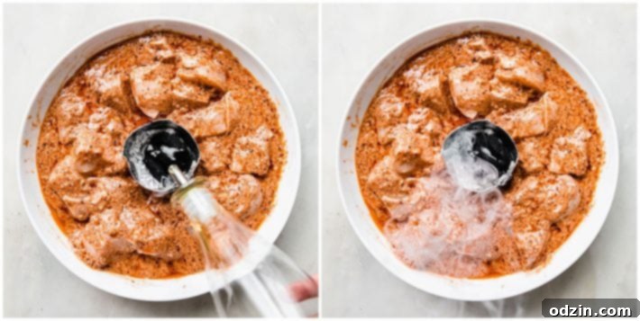 Detailed shot of the optional smoking technique for Shish Tawook, showing hot charcoal in a foil basket within the chicken marinade, releasing smoke