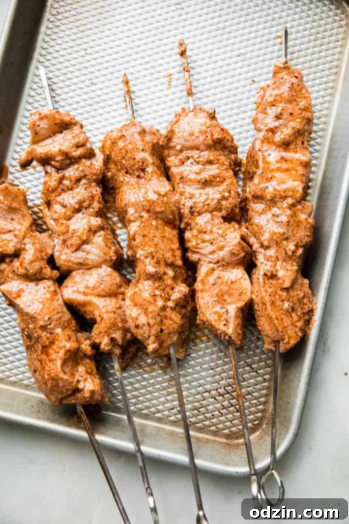 Cooked chicken skewers arranged neatly on a sheet pan, ready for serving or meal prep