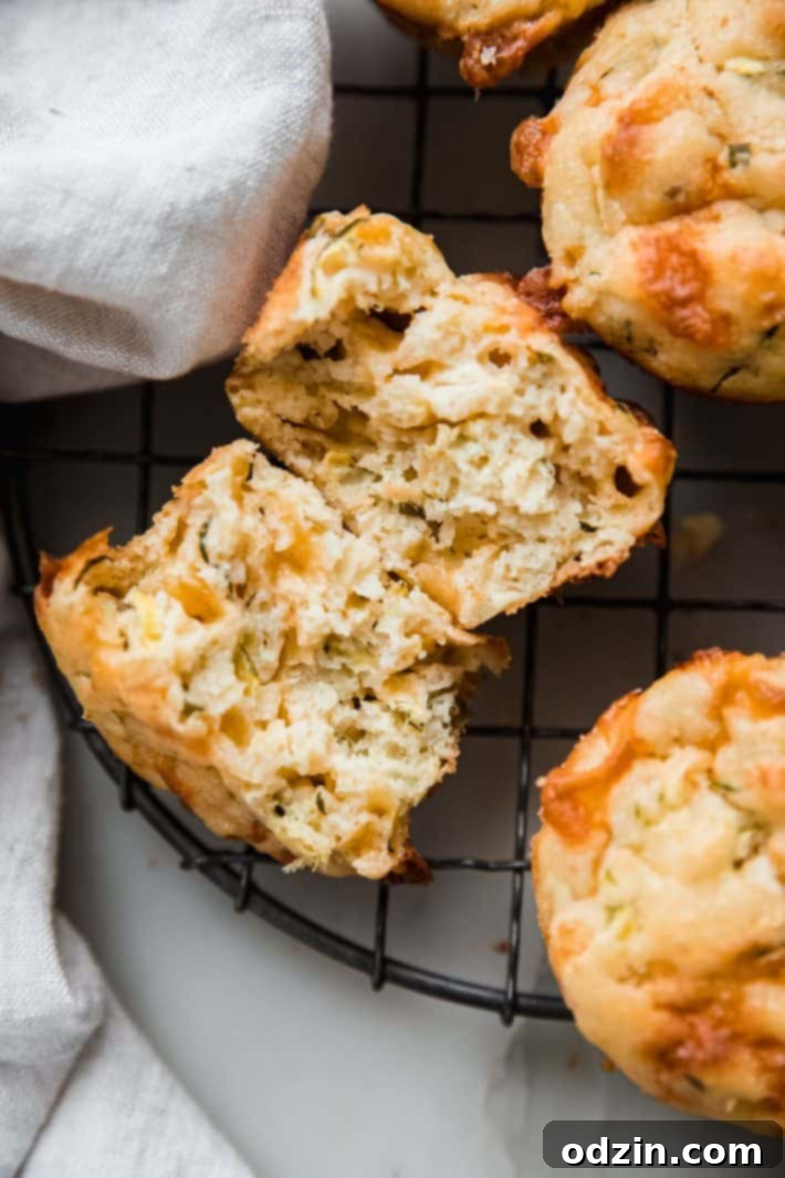 split zucchini muffin showing cheese