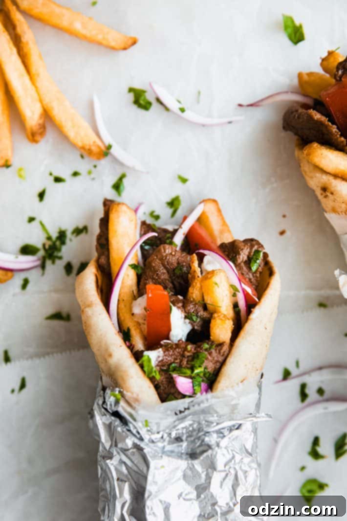 Delicious beef souvlaki wrap served on white paper, ready to eat.