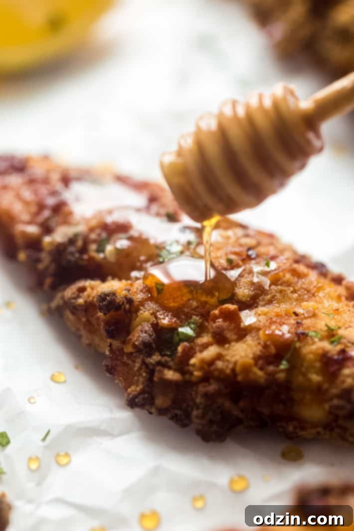 Your Go-To Homemade Hot Honey Recipe for Pizza Tenders and Beyond 4 Honey drizzling on chicken tender