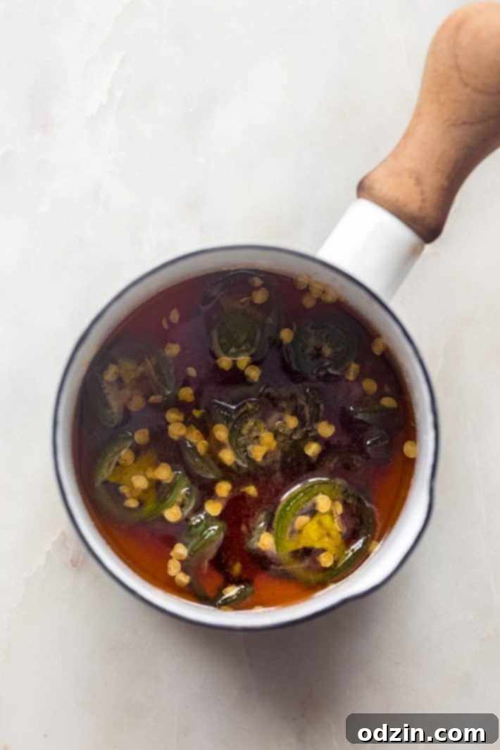 Your Go-To Homemade Hot Honey Recipe for Pizza Tenders and Beyond 5 Hot honey in saucepan