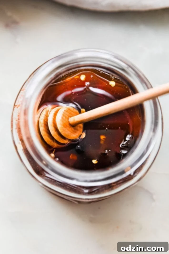 Your Go-To Homemade Hot Honey Recipe for Pizza Tenders and Beyond 6 Sauce with honeycomb in jar