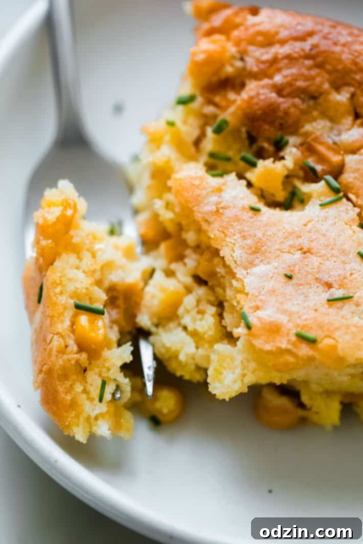 Close-up of the creamy texture and golden brown crust of the Boursin Jiffy Corn Casserole, showcasing its delicious appeal.