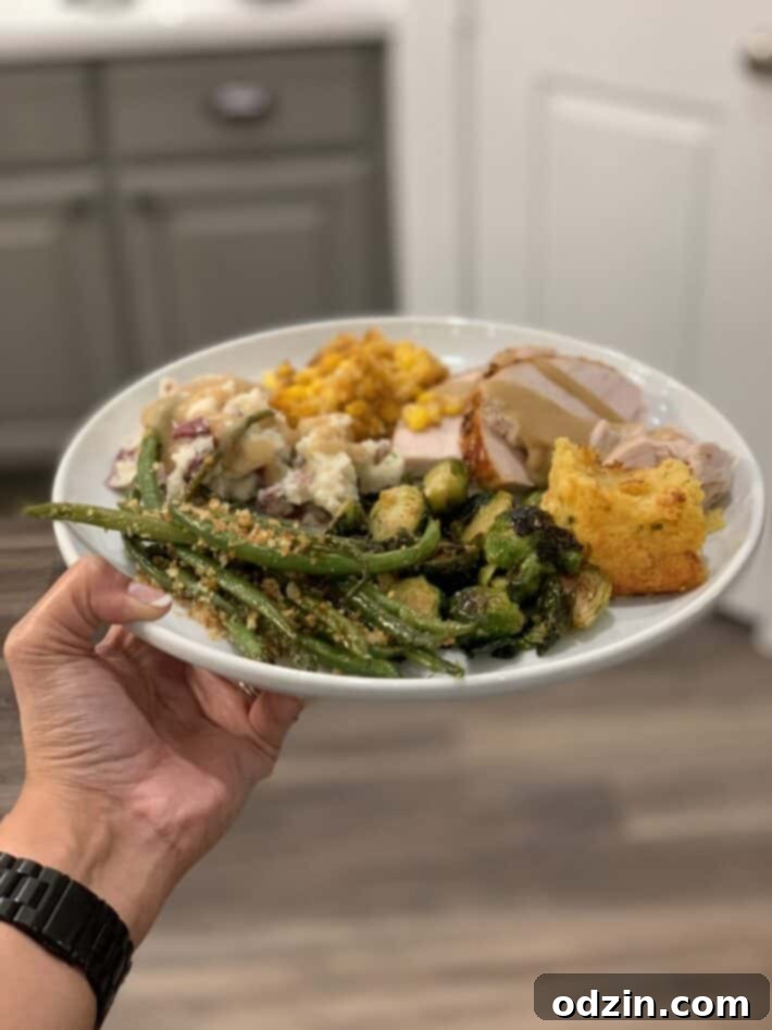 A festive plate filled with various Thanksgiving dishes, including a generous serving of the Jiffy Corn Casserole with Boursin.