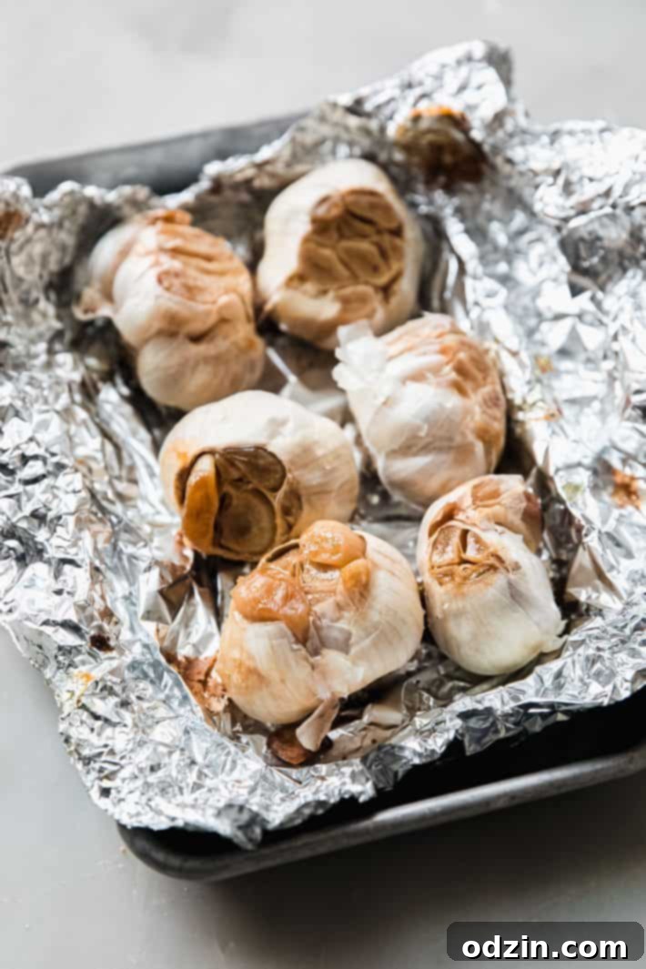 roasted garlic on on foil and sheet pan