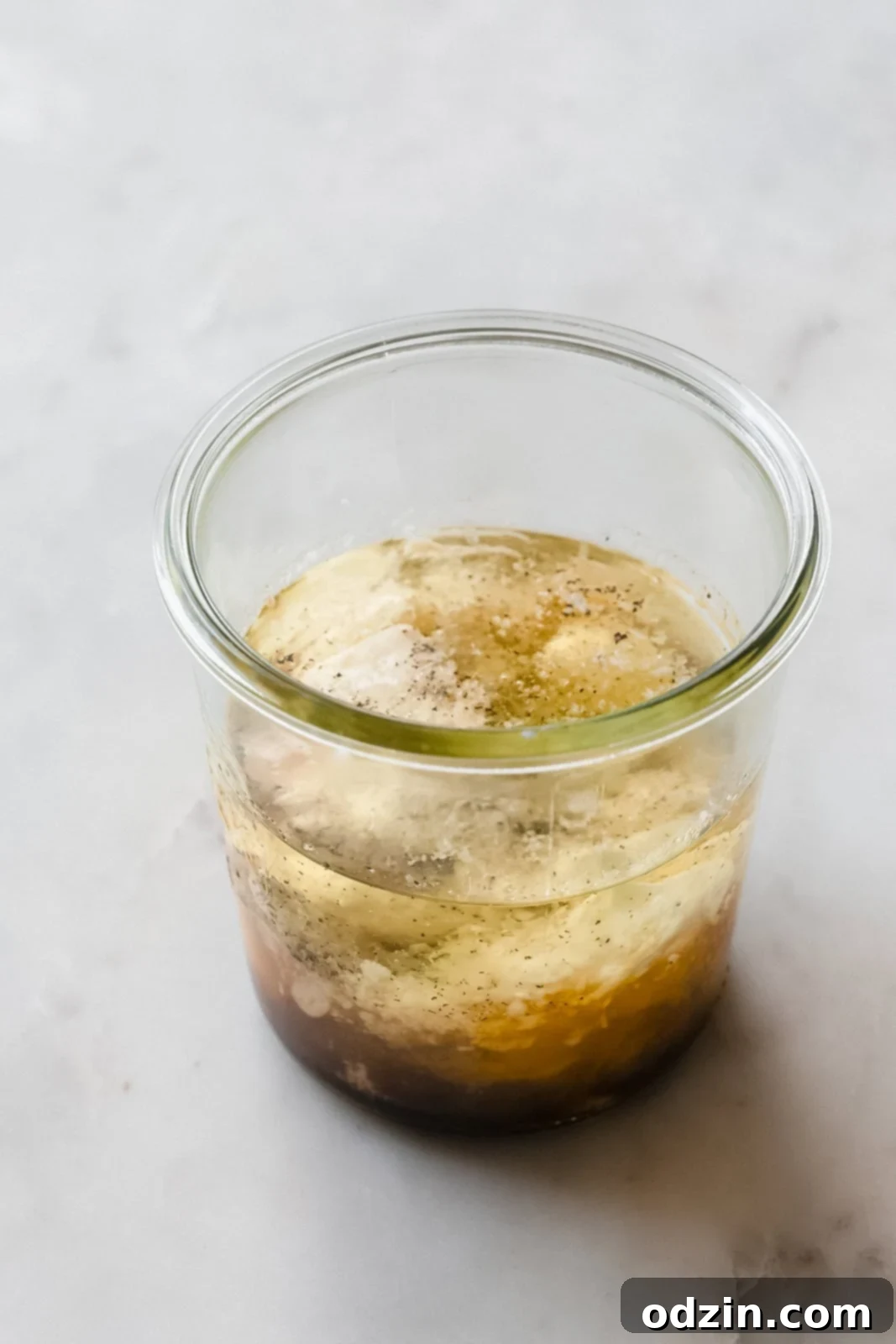 Caesar Dressing in 2 Minutes 4 Assorted ingredients for Caesar salad dressing, prepped in a jar, ready for blending