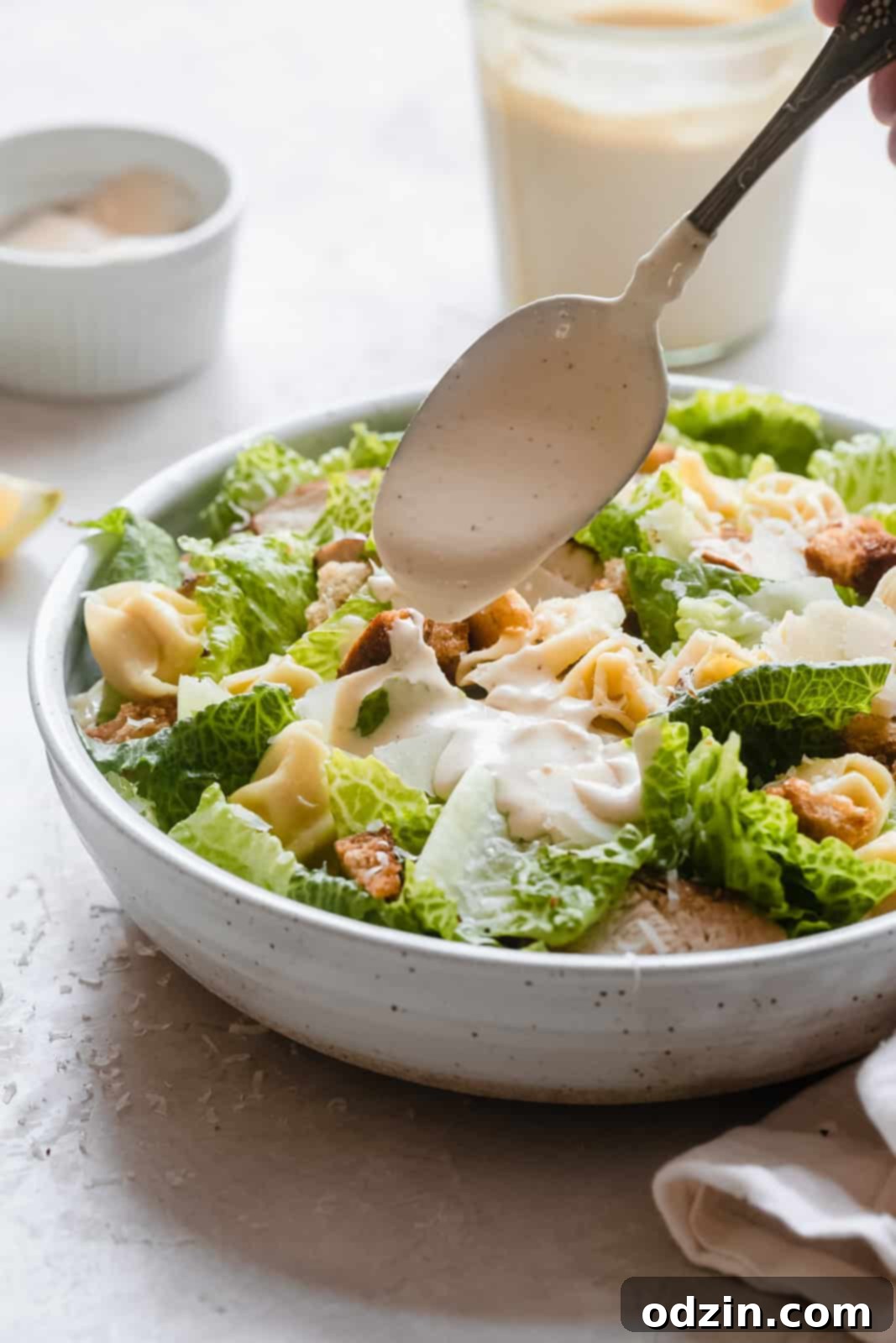 Caesar Dressing in 2 Minutes 6 Dressing a Caesar tortellini salad with prepared homemade Caesar dressing using a spoon