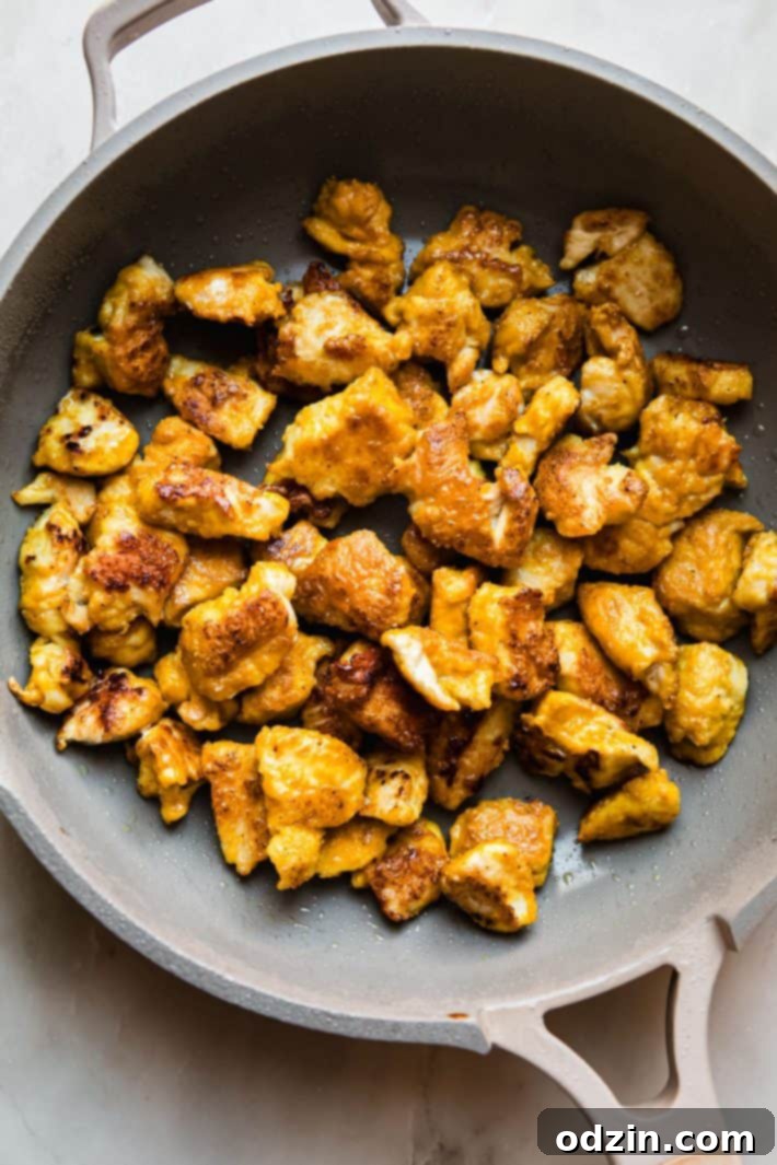 pan-fried turmeric chicken in skillet