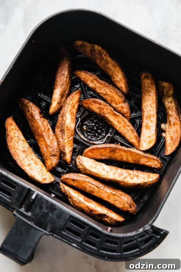 Crispy Air Fryer Potato Wedges 5 wedges after air frying in basket