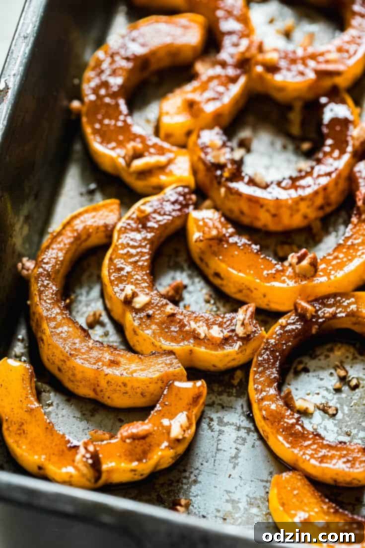 Maple Roasted Delicata Squash, perfectly golden and caramelized, ready to be served as a festive side dish.
