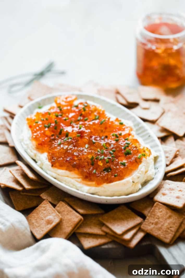 Quick and Easy Pepper Jelly Cheese Dip 5 prepared dip on serving board with crackers