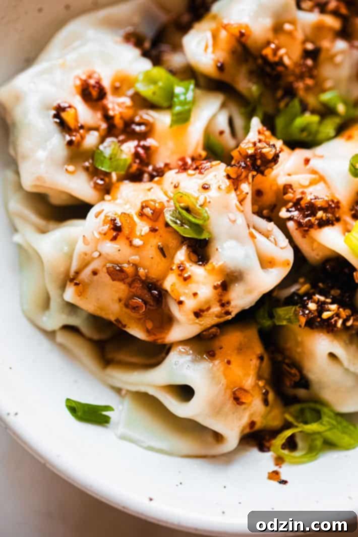 chicken wontons topped with homemade chili oil and scallions