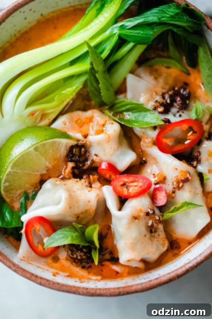 close up of chicken wontons with chili crisp and Fresno chili on top