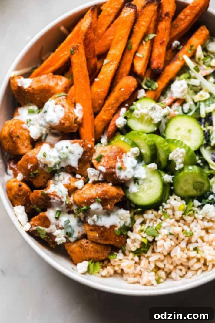 Close-up of a buffalo chicken bowl with blue cheese on top, ready to be eaten
