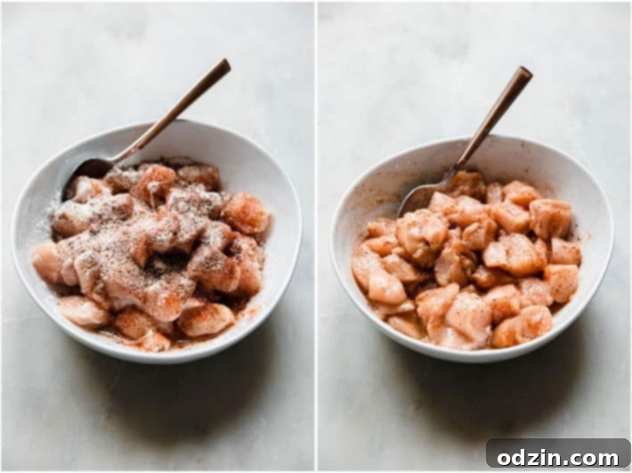 Chicken pieces marinating in a bowl with a spoon