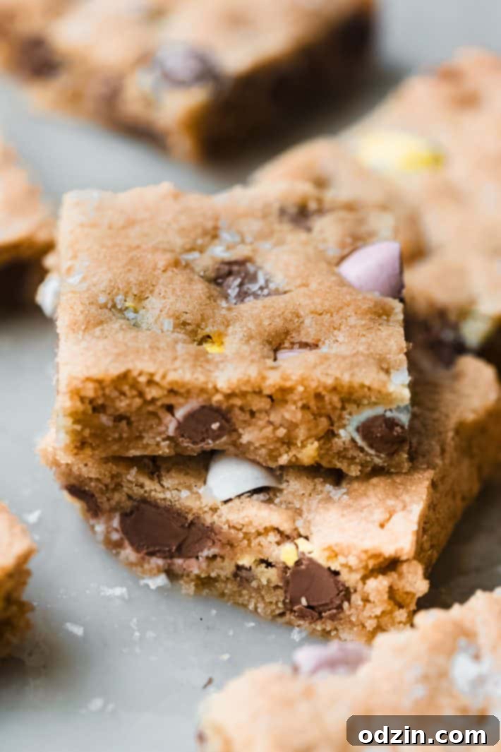 Decadent Brown Butter Cadbury Mini Egg Blondies 7 mini egg cookie bars on marble with maldon salt on top