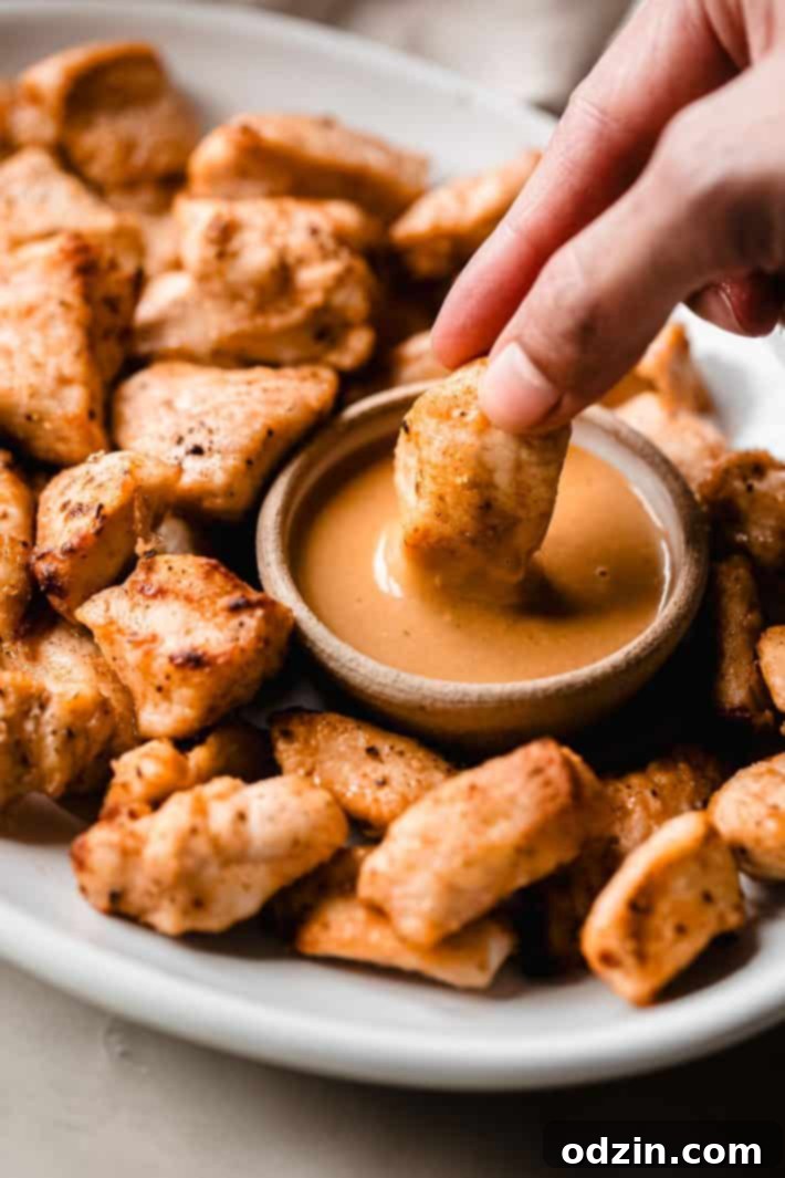 dipping grilled nugget in sauce