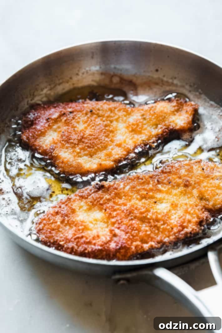 frying the chicken in skillet to golden perfection