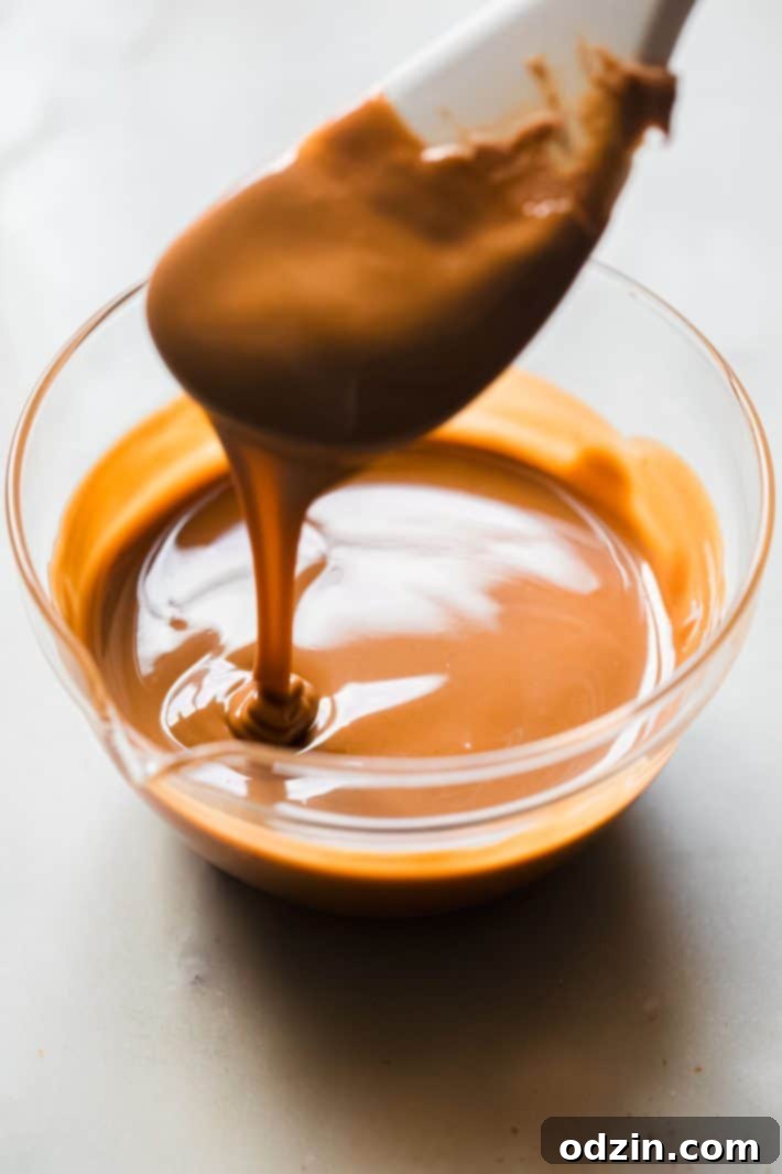 Close-up of melted Biscoff cookie butter being drizzled into a bowl