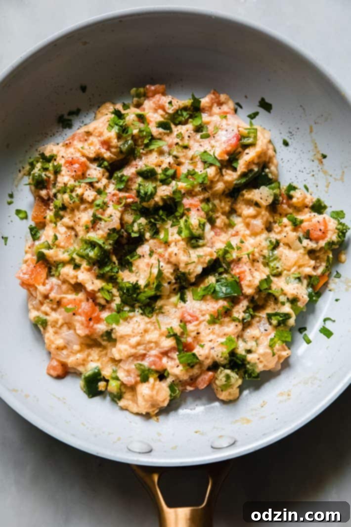 skillet with huevos a la mexicana topped with cilantro