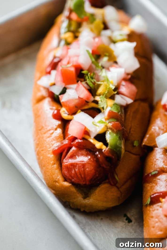 Brioche bun with a cross-hatched hot dog, topped with vibrant pickled jalapeño pico de gallo