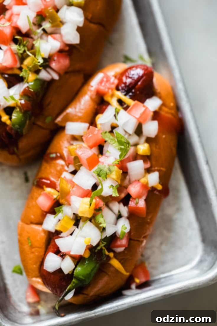 Mexican hot dog loaded with pickled jalapenos onions and tomato pico