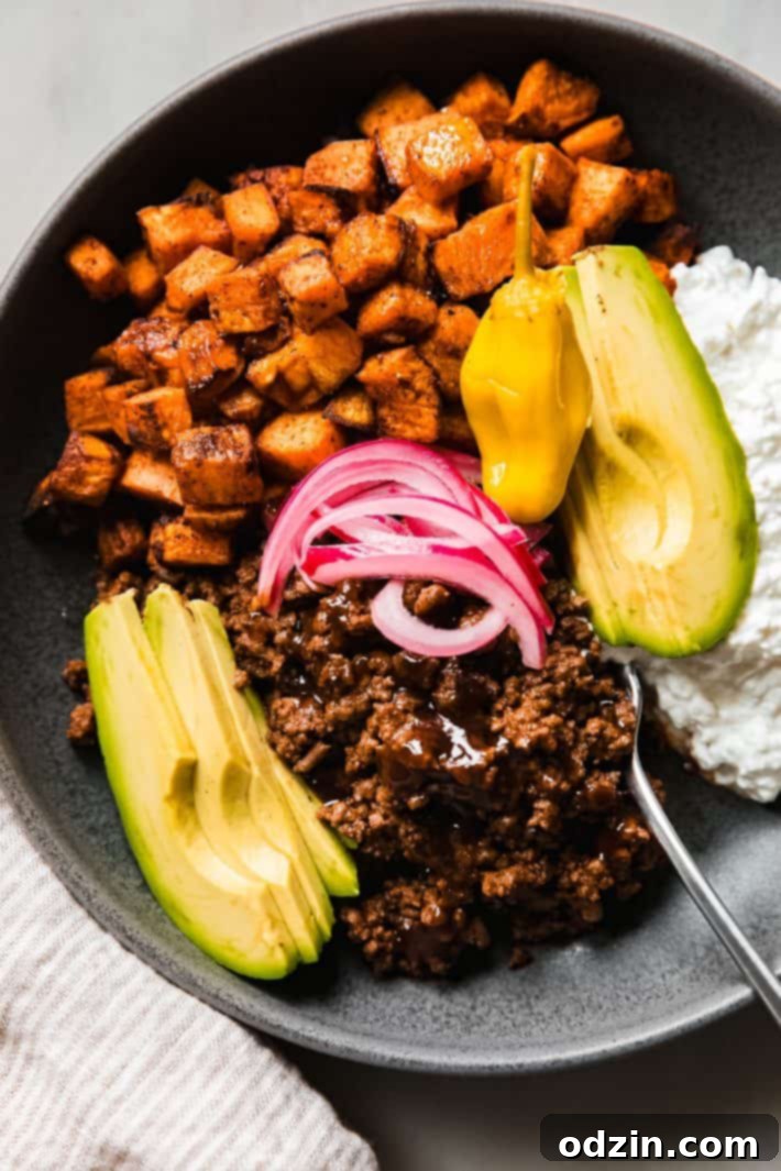 sweet potato bowl with taco meat, pepperoncini, pickled onions and cottage cheese