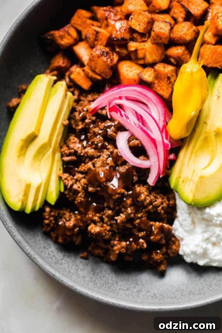 close up of taco meat, avocado and pickled onions