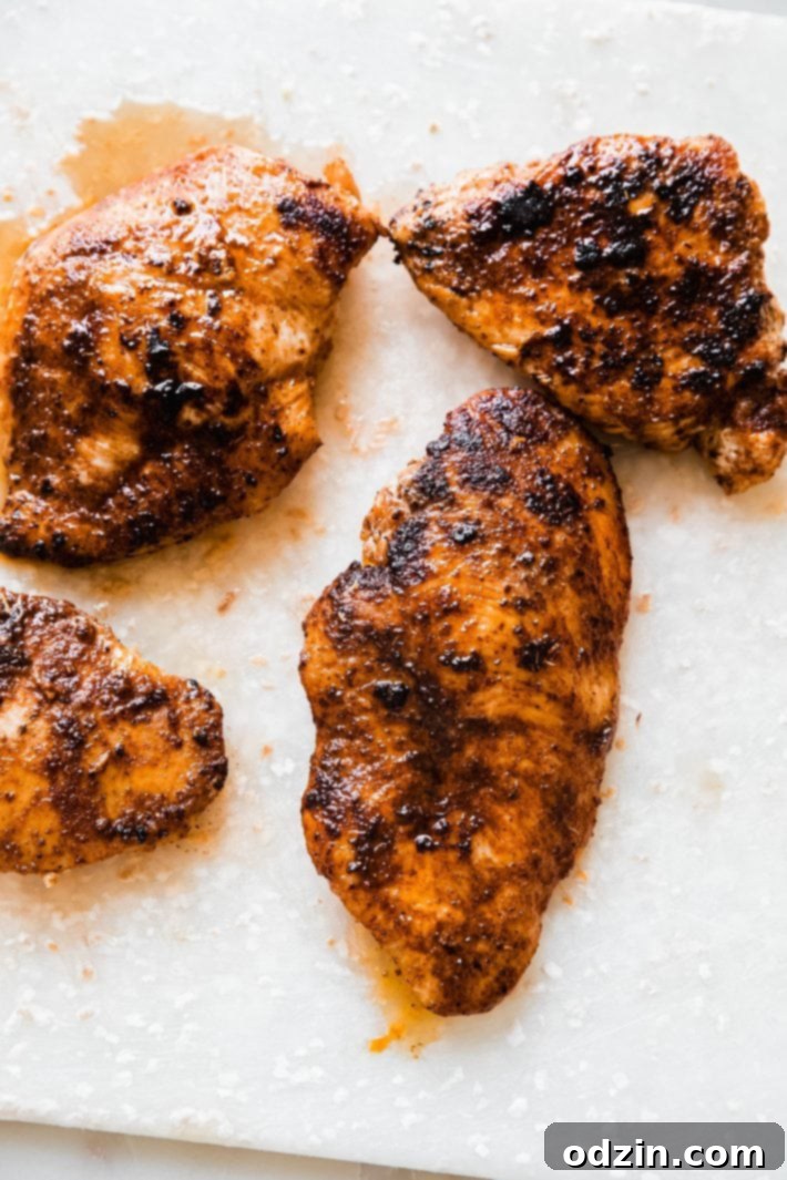 cooked blackened chicken on cutting board