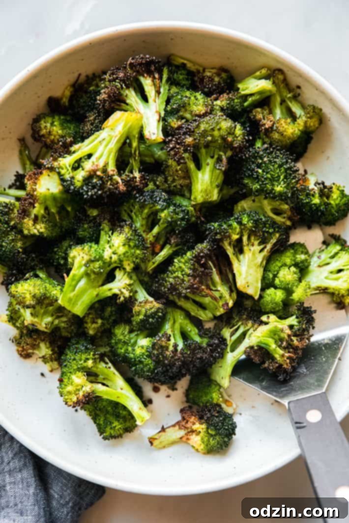 air fryer broccoli in bowl with spatula