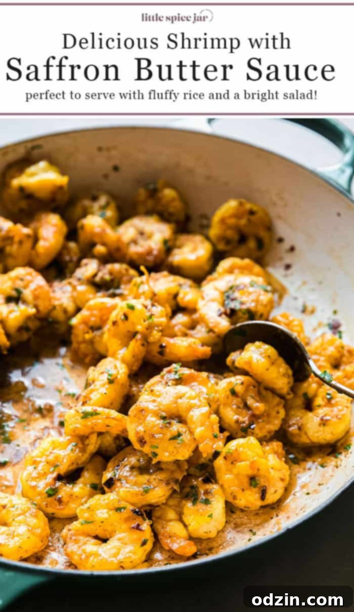 Cooked shrimp with saffron butter sauce on a plate, ready to be served, accompanied by rice and salad.