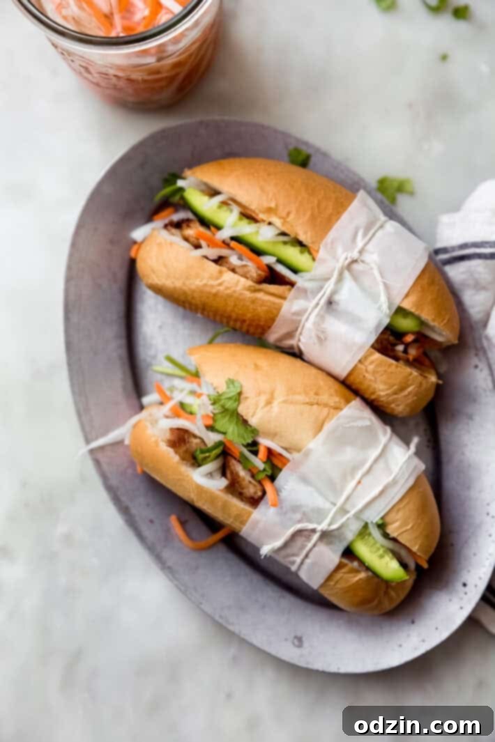 Multiple homemade chicken Banh Mi sandwiches arranged on a serving plate, ready to be enjoyed.