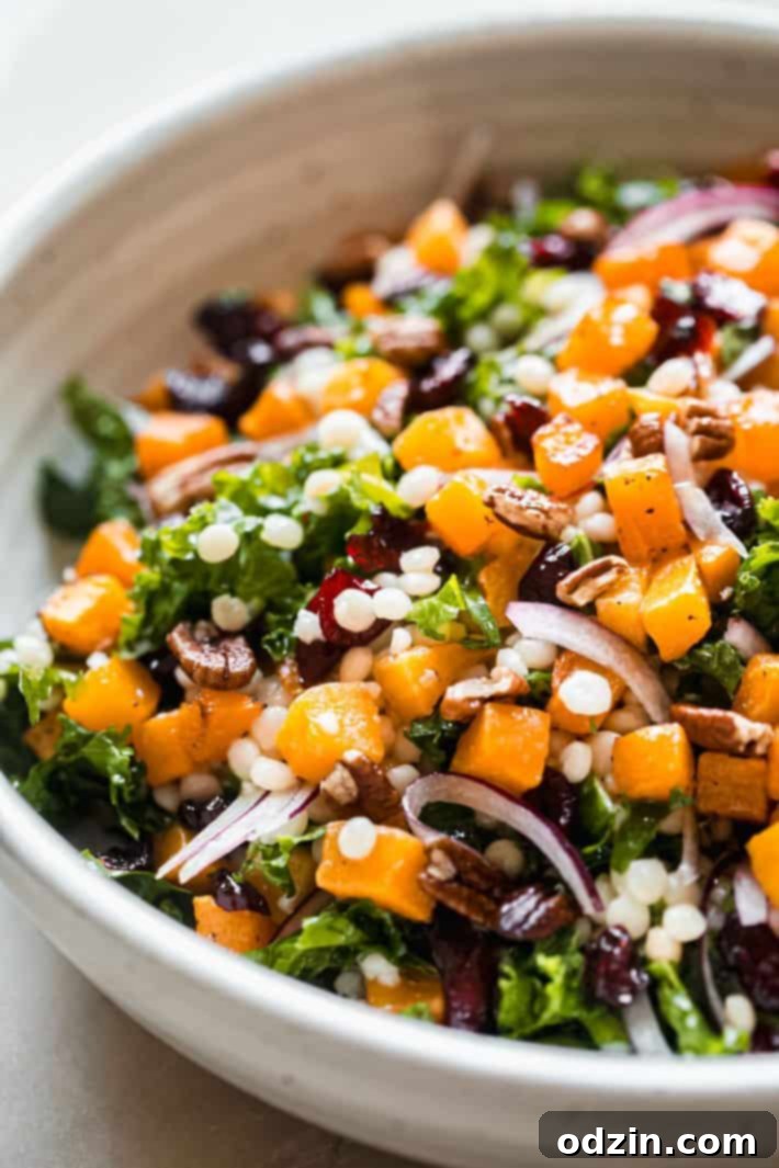 Autumn Glow: Roasted Butternut & Pearl Couscous Salad 3 roasted squash on top of pearl couscous with cranberries, pecans, kale, and red onions