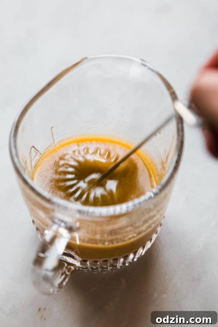 Autumn Glow: Roasted Butternut & Pearl Couscous Salad 6 whisking dressing in measuring cup