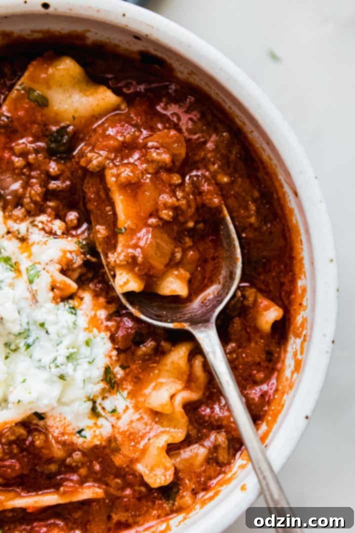 lasagna soup on spoon from bowl