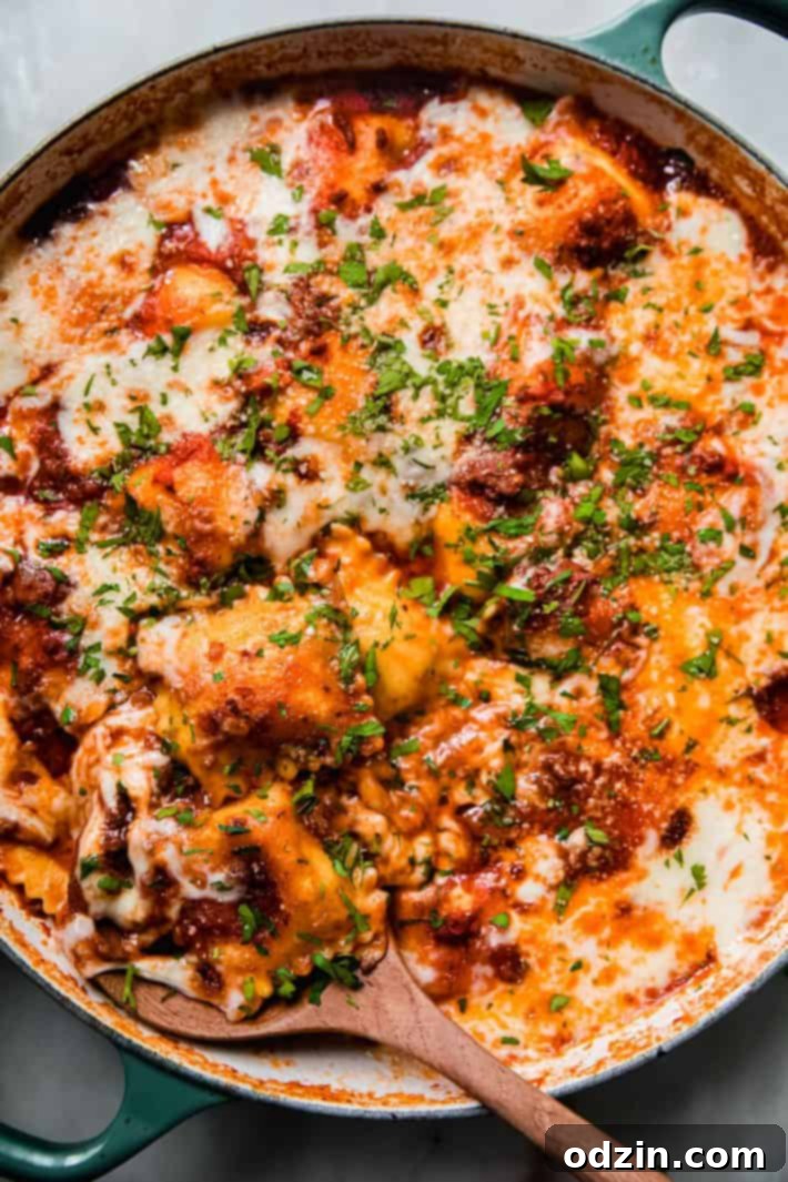 Cheater's Skillet Ravioli Lasagna 2 Delicious skillet lasagna with tender ravioli and rich meat sauce, served with a wooden spoon