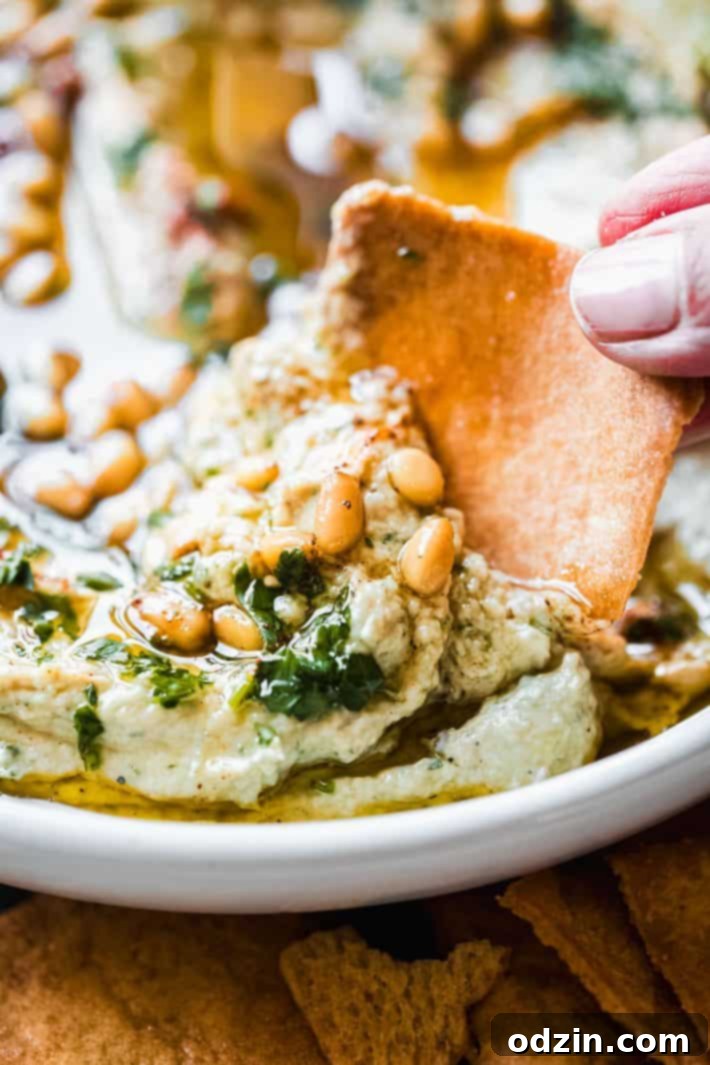 Close-up of creamy baba ganoush in a serving bowl, ready to be enjoyed.