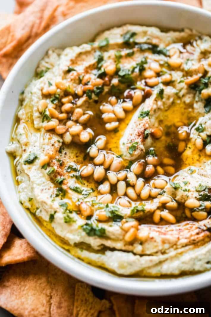 Another view of the baba ganoush in a bowl, with fresh pita bread and olive oil nearby.