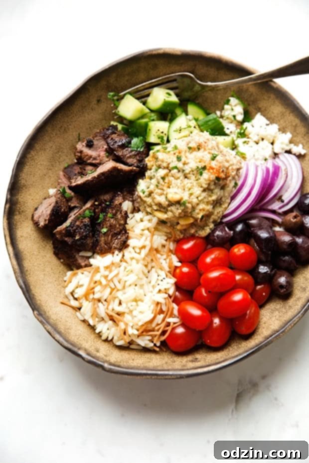 Delicious Beef Shawarma Bowls with Vermicelli Rice Pilaf, topped with fresh vegetables for a complete meal. Perfect for an easy, flavorful Middle Eastern lunch or dinner. #shawarma #shawarmabowl #vermicellirice #beefshawarma